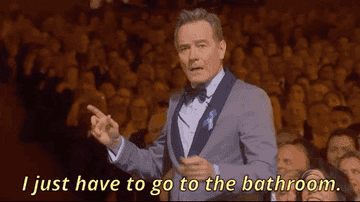 GIF of Bryan Cranston saying he needs to go to the bathroom during the Tonys 