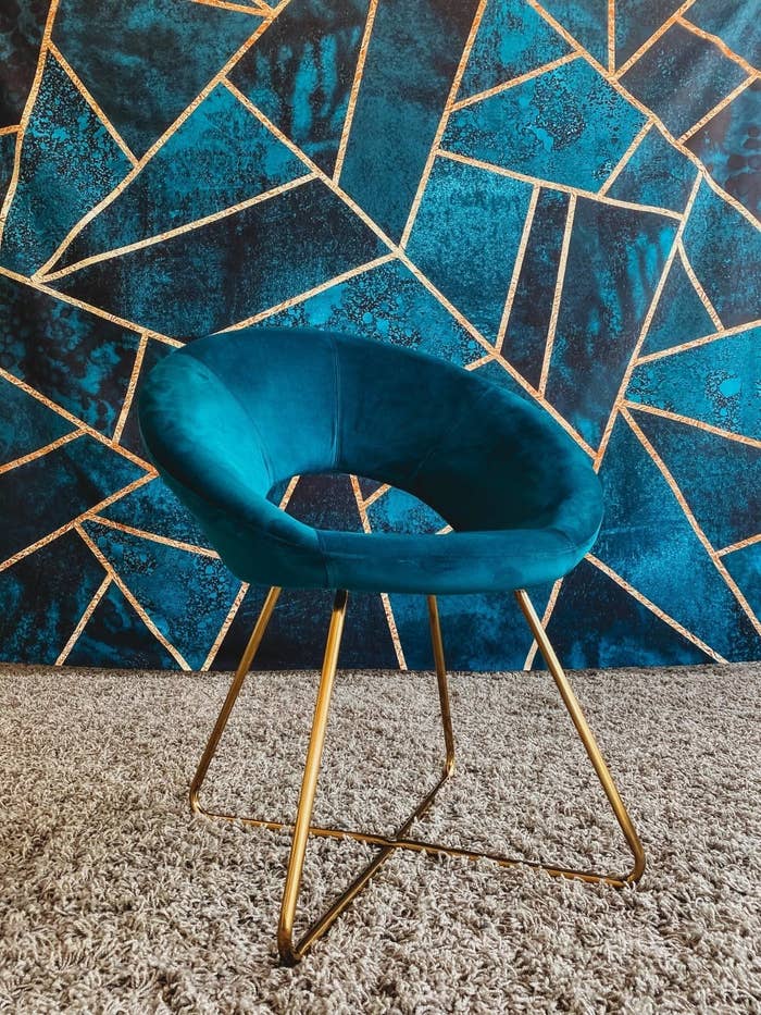 reviewer photo of a  round teal accent chair with gold legs
