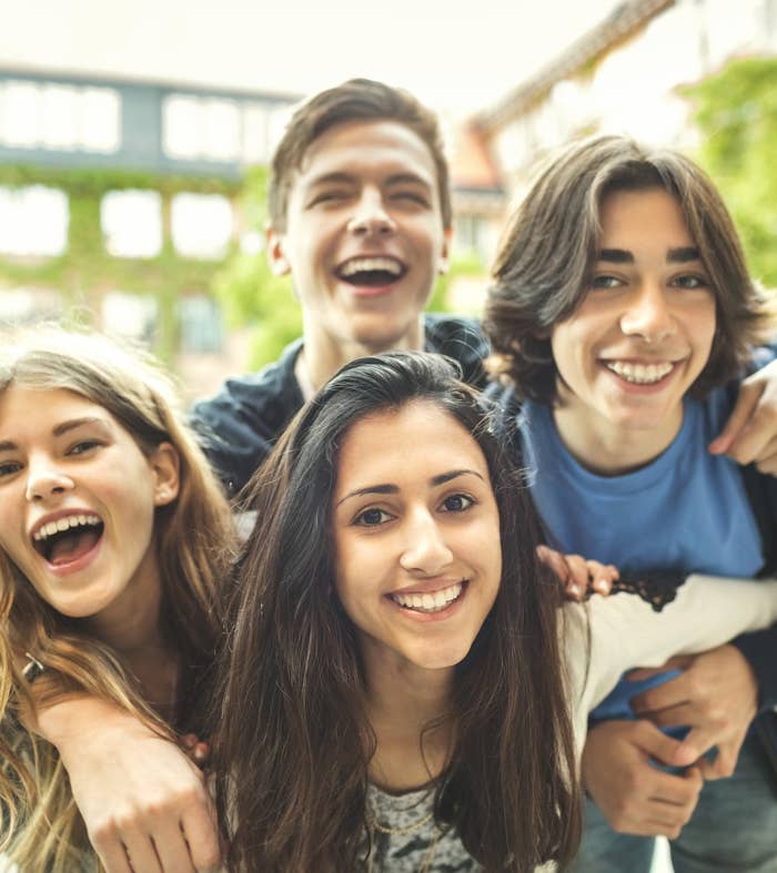 Four teens hugging