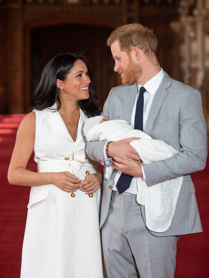 Prince Harry (R) and Meghan Markle pose with their newborn son Archie Harrison Mountbatten-Windsor