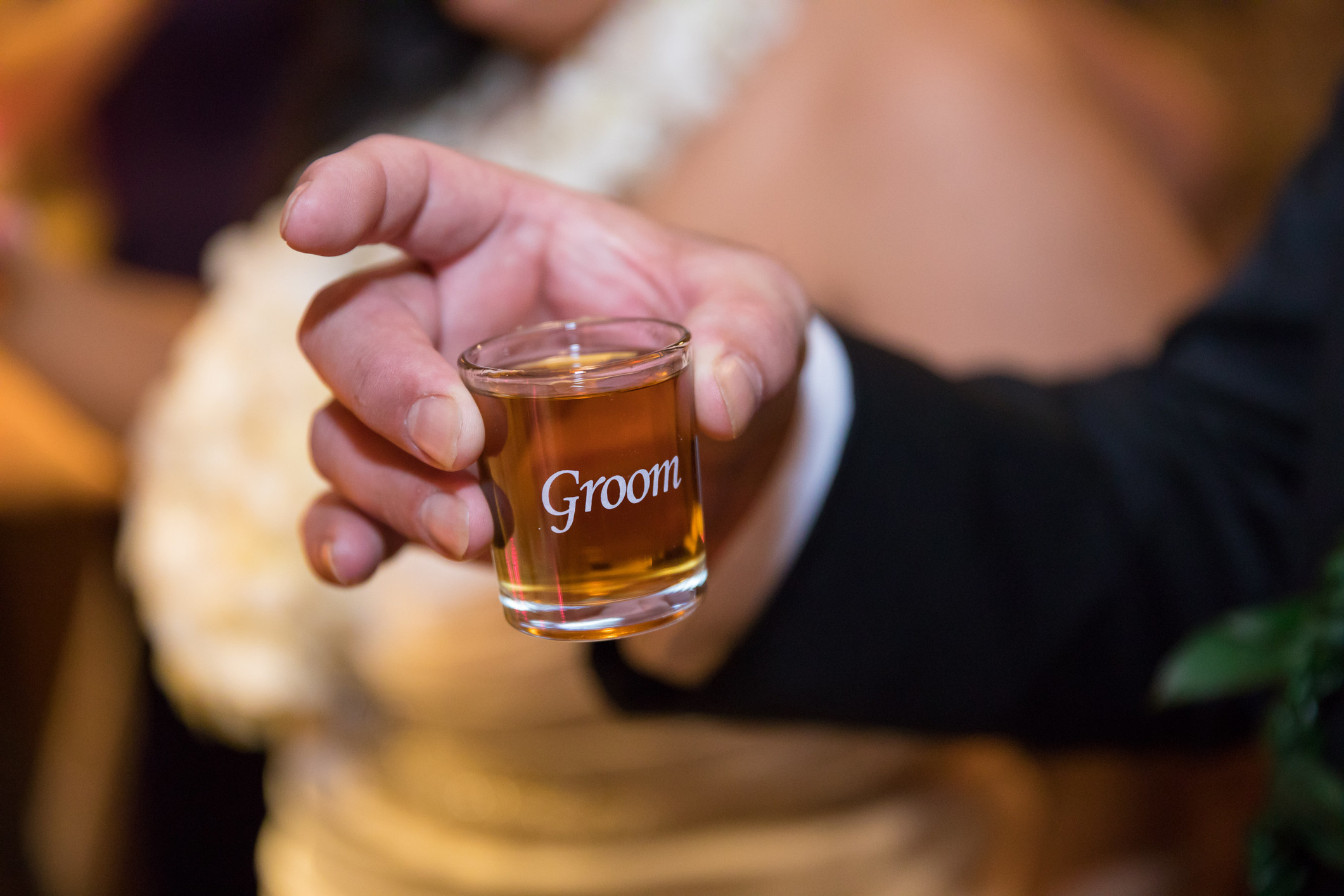 A shot glass that says &quot;groom&quot; on it