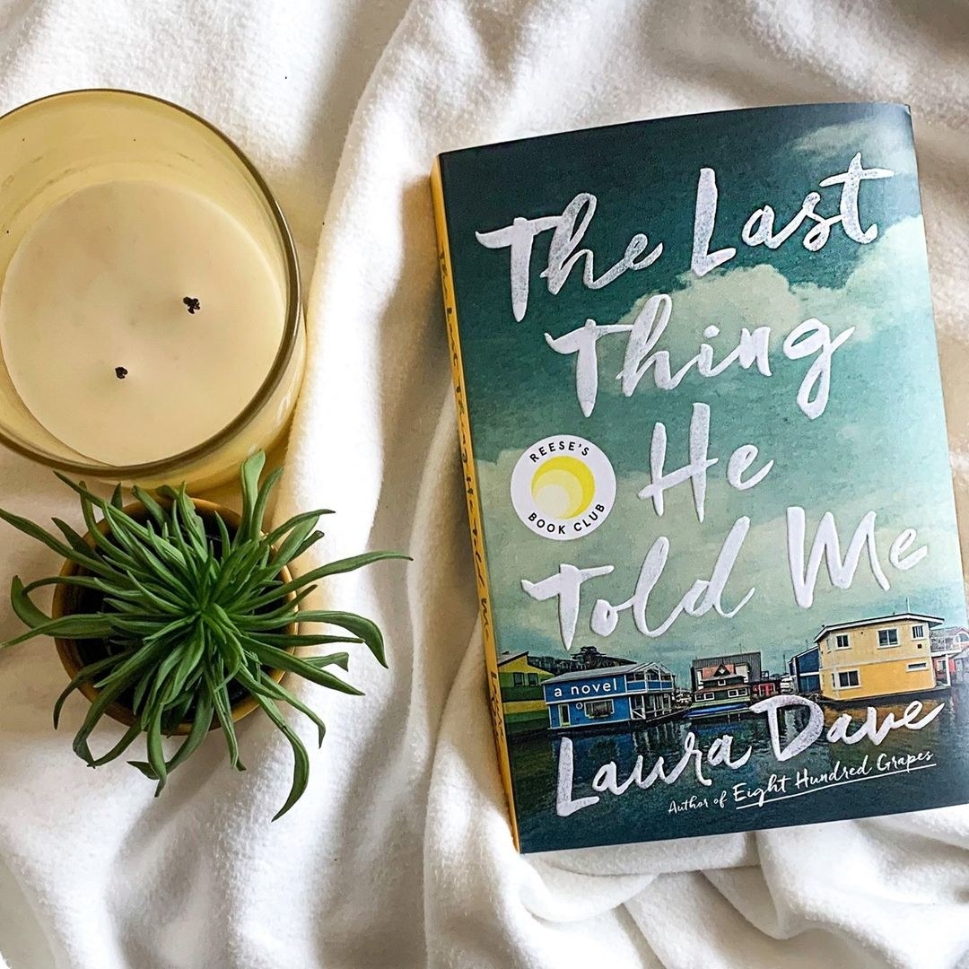 A hardback novel called the last thing he told me on a blanket