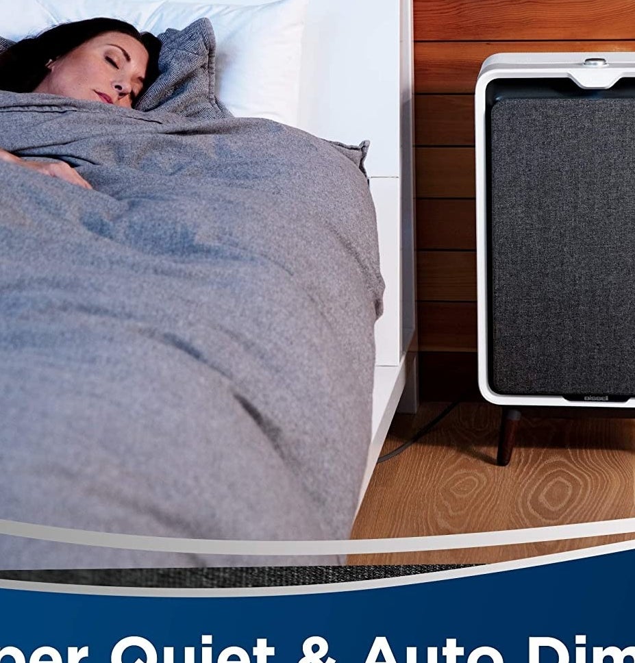 The air purifier next to a bed