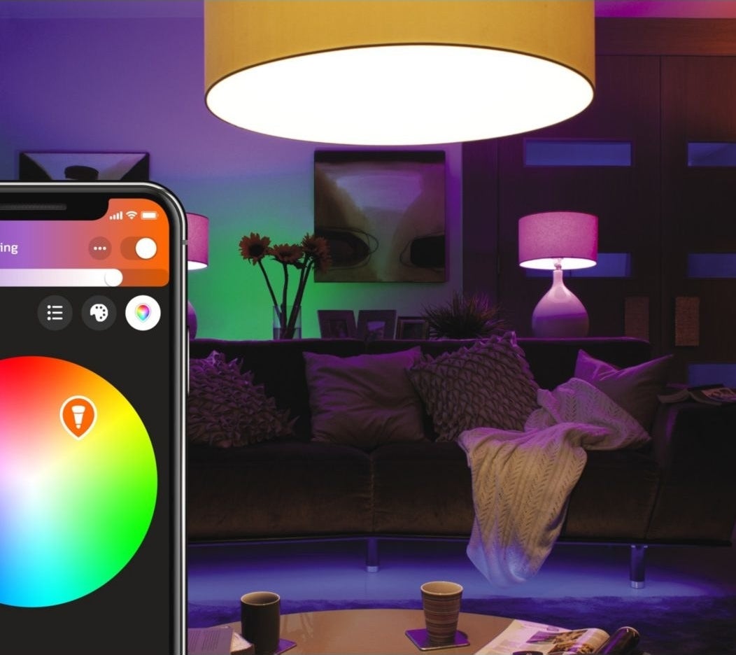 A phone adjusting the colours of the lights in a home
