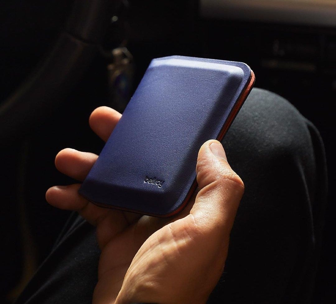 A man holding a slim wallet