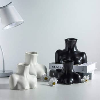 The black and white vases in both the small and large sizes displayed on a table