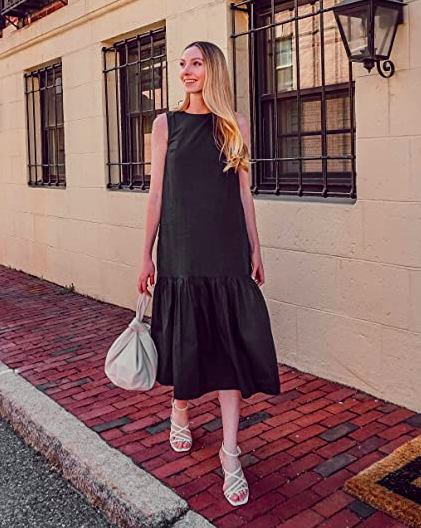 A person strolling down the street while wearing the ruffled maxi dress