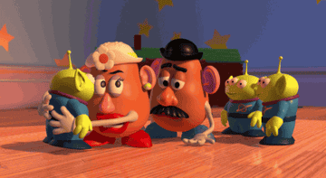 a gif of mr potato head being hugged by alien toys
