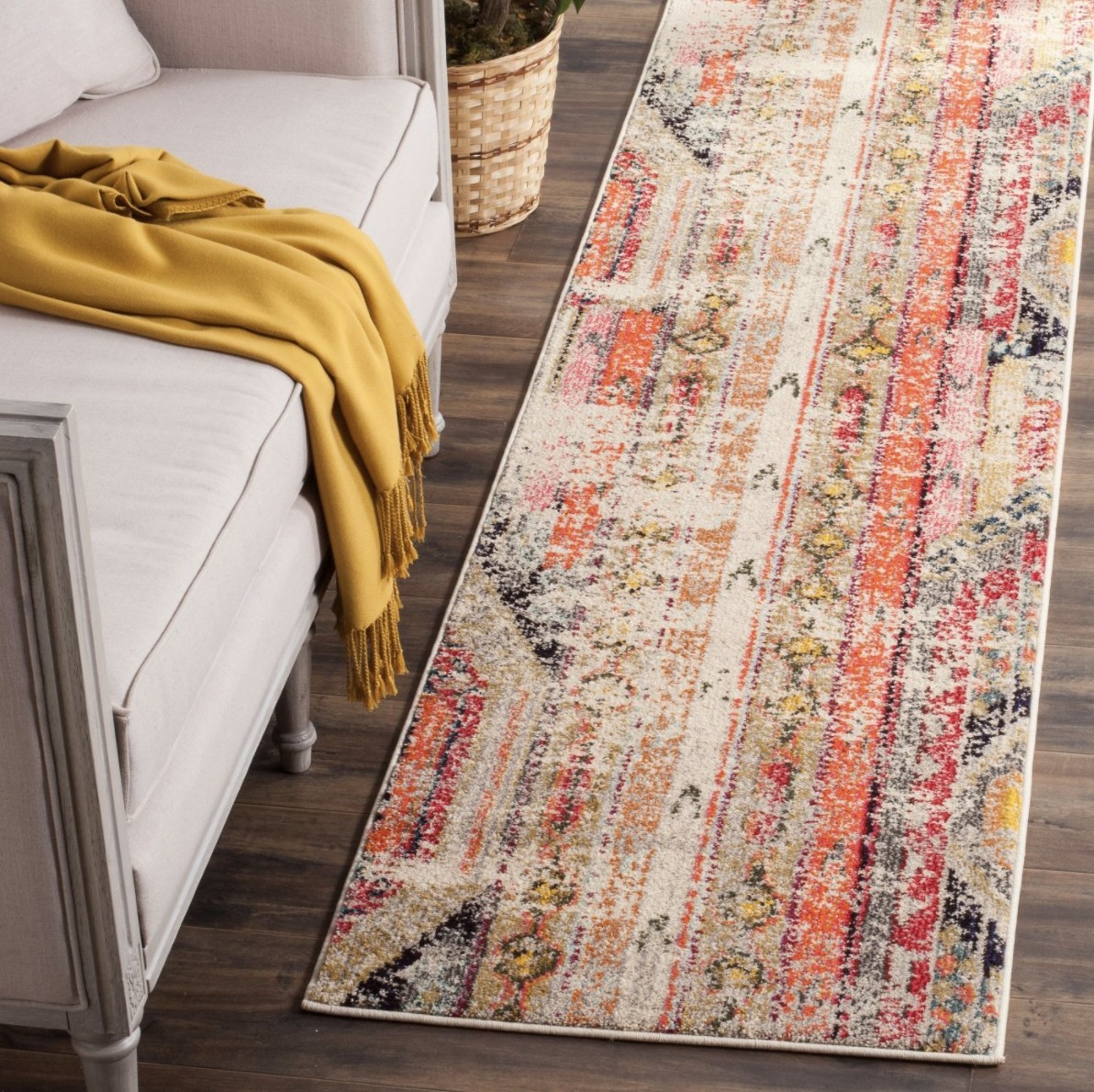 The long rectangular rug mixes yellows, blacks, oranges, reds and various other vibrant colors