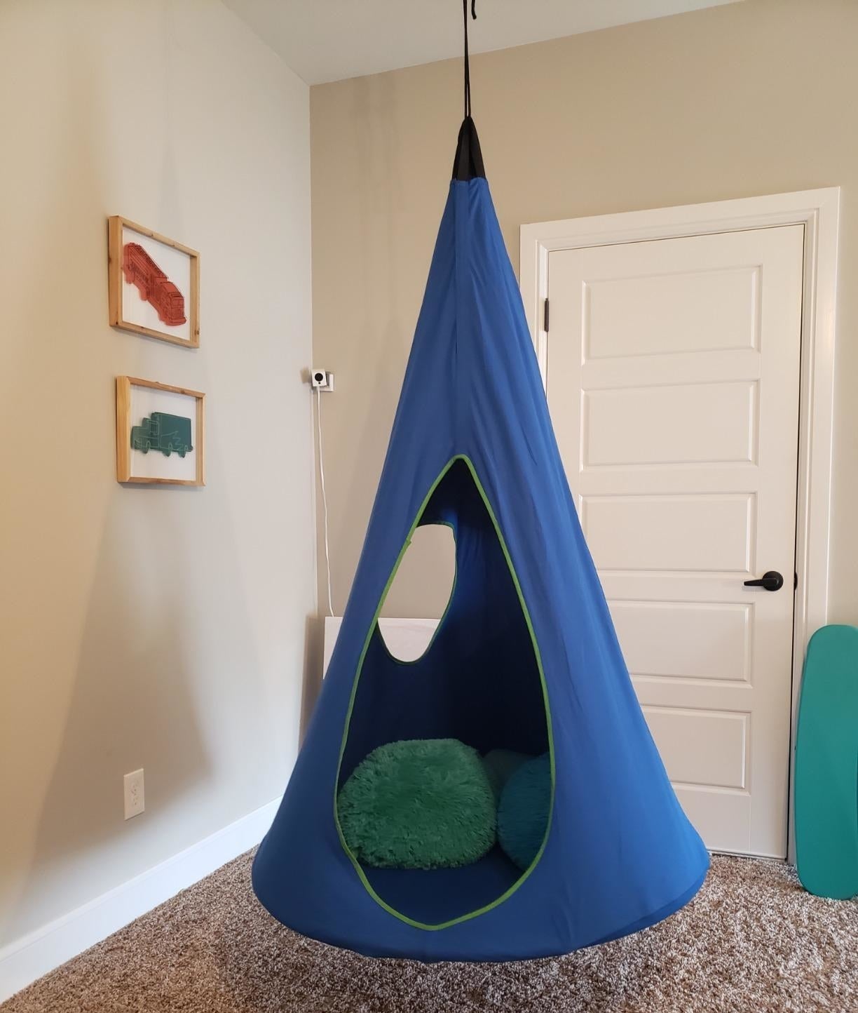 the cocoon hammock in blue in a bedroom 