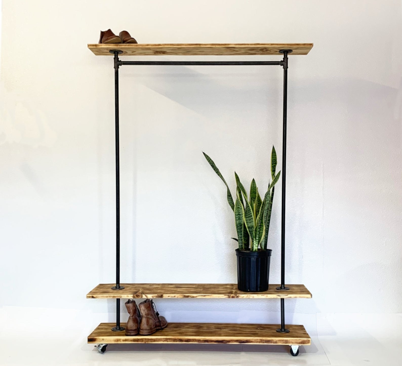 Coat and shoe rack on white background