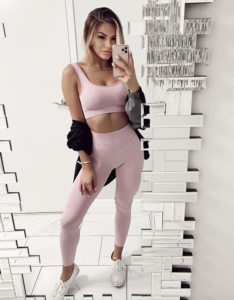 reviewer wearing the pink leggings and sports bra