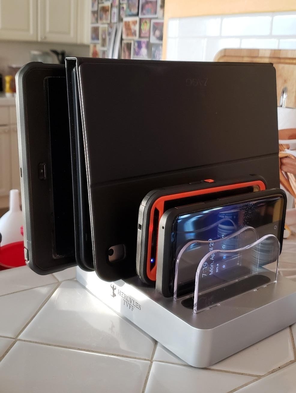 a reviewer&#x27;s docking station with several devices charging on a countertop