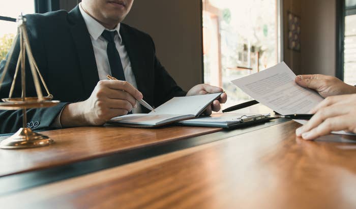 A lawyer going over paperwork with a client