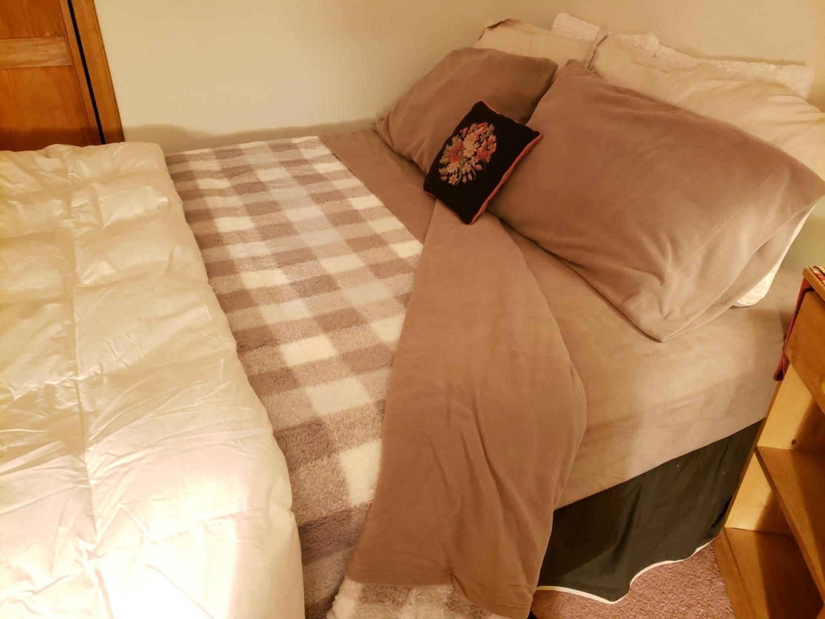 A set of sheets in taupe on a reviewer&#x27;s queen bed