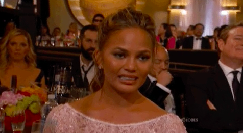 Chrissy Teigen looking awkward at the 2015 Emmy Awards