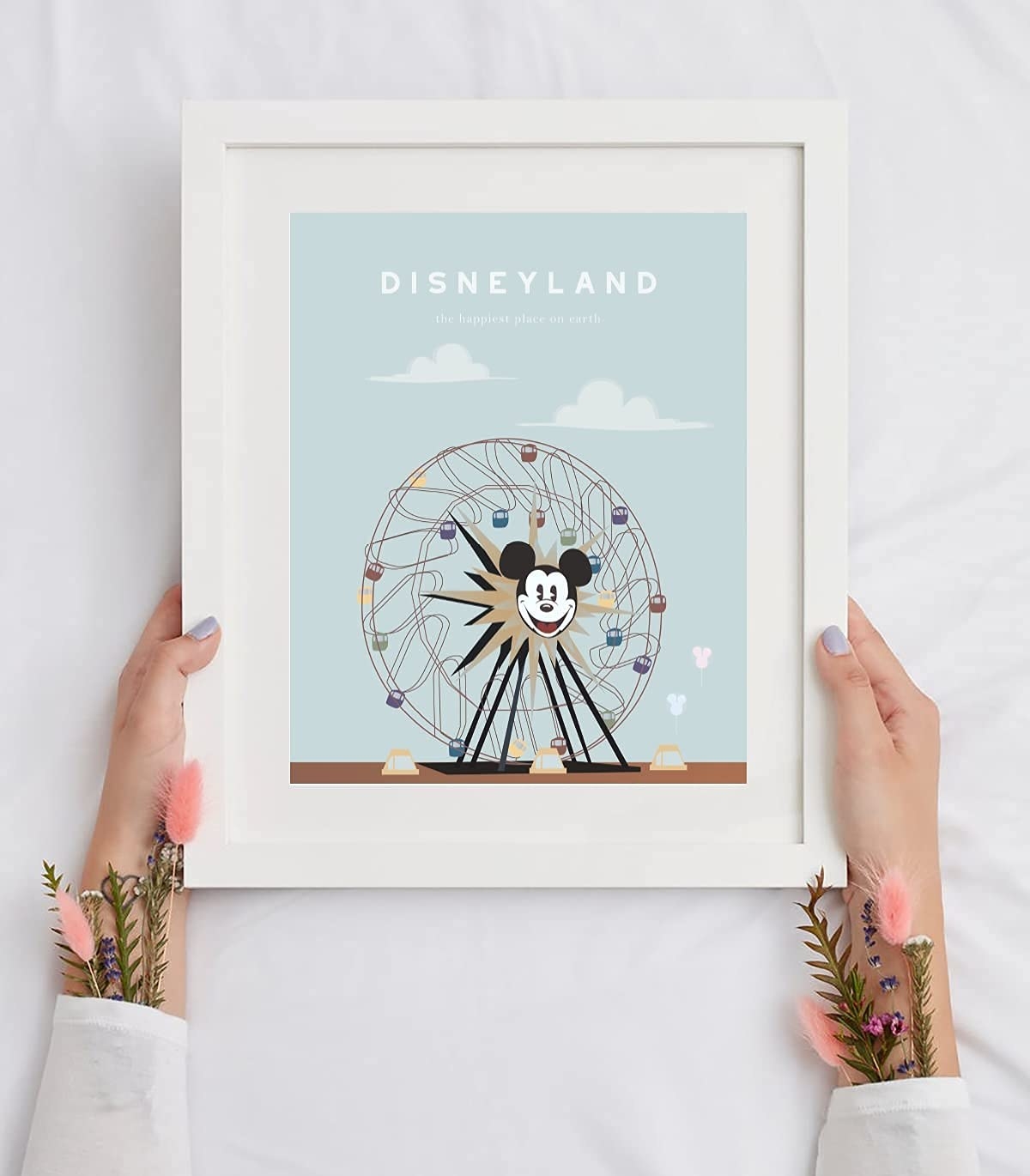 a light blue print of the ferris wheel in a white frame