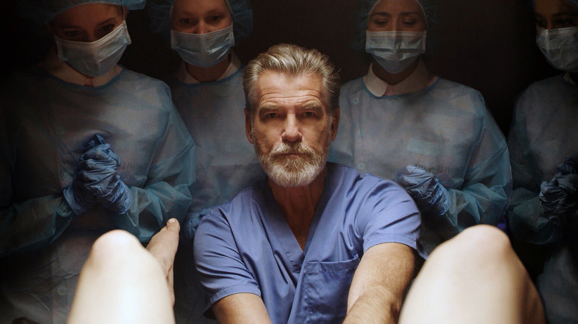 Pierce Brosnan as a doctor delivering a baby in the movie false positive