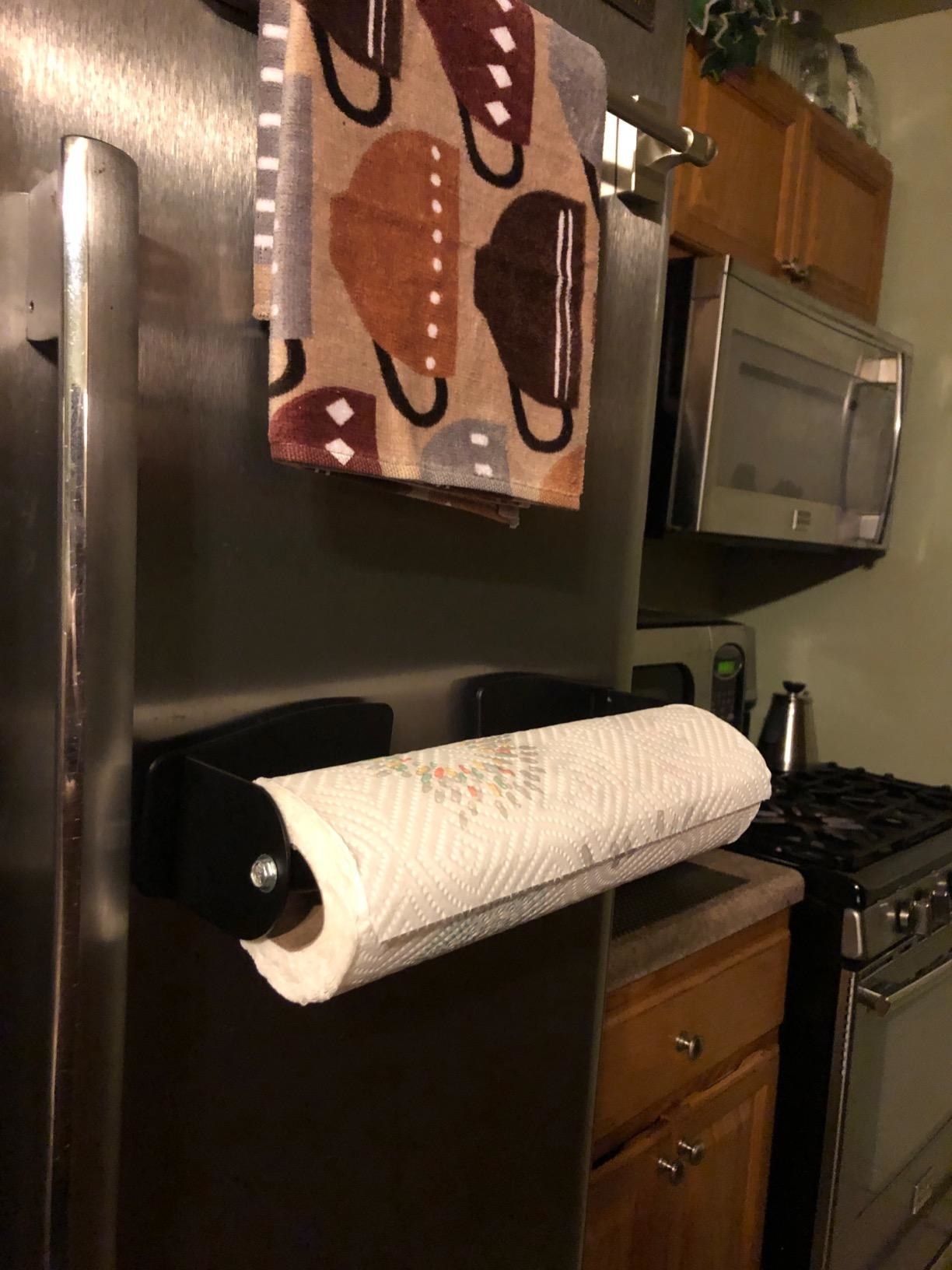 A reader photo of a paper towel holder stuck to a fridge