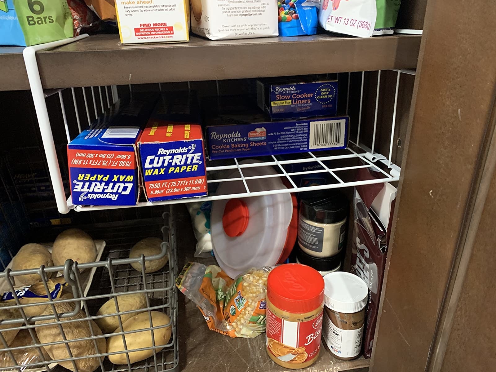 A reviewer photo of the shelf hanging in a cupboard