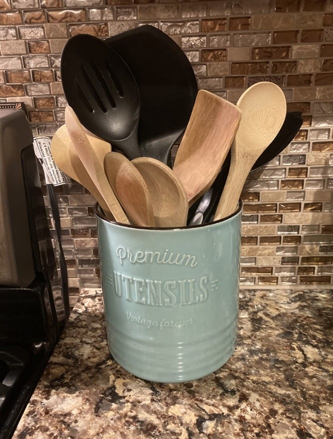 The utensil holder in blue on a reviewer&#x27;s counter 