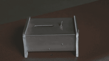 Gif of a person flipping a switch on a metal box. Then a handle comes out and switches the switch back off. 
