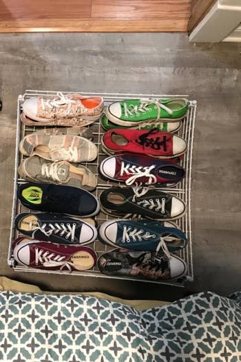 a reviewer photo of the same carts pulled out from under the bed and filled with shoes 