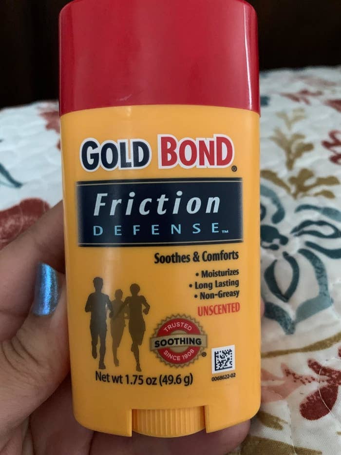 a reviewer photo of a hand holding up the gold bond friction defense stick