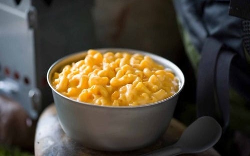 The mac and cheese prepared hot in a camp bowl