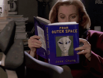Agent Scully reading a book called From Outer Space