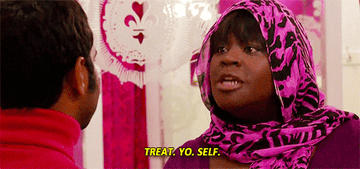 A gif from Parks and Recreation where Donna tells Tom &quot;treat yo self&quot; 