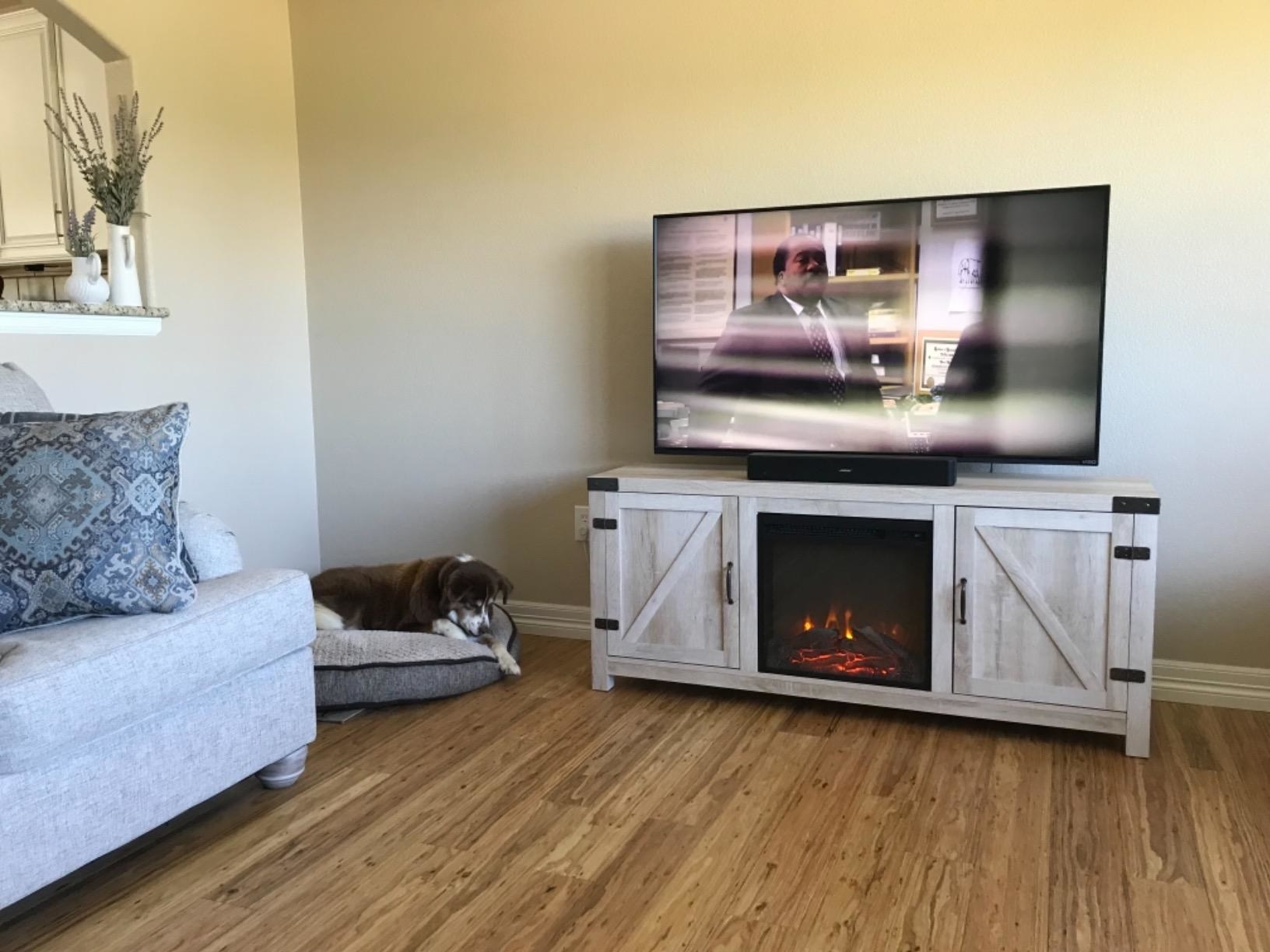 reviewer photo of a farmhouse TV stand with electric fireplace built in
