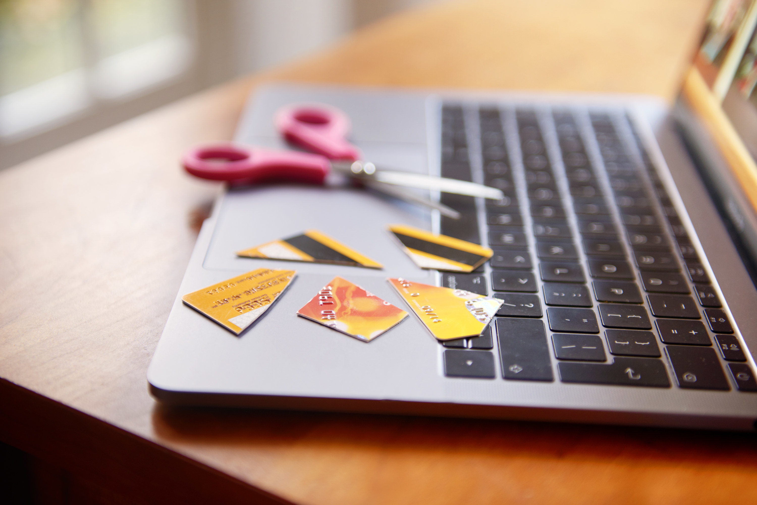 Cut-up credit card on a laptop keyboard