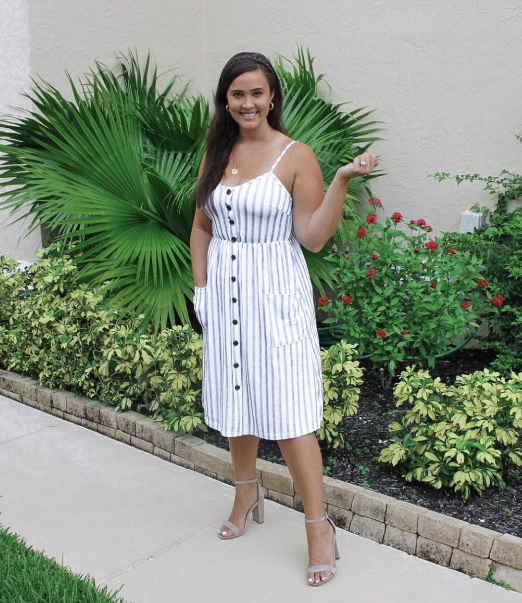 A person wearing a white and blue button-down dress
