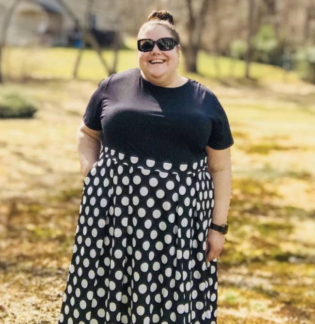 Reviewer wearing a black and white polka dot dress