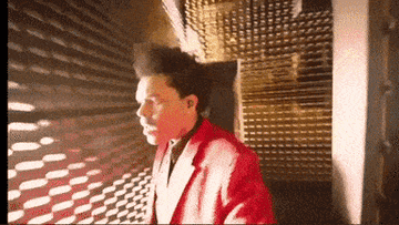 gif of r n b singer the weekend looking walking through a maze as if lost