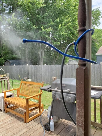 reviewer photo of a blue mister attachment wrapped around a pole