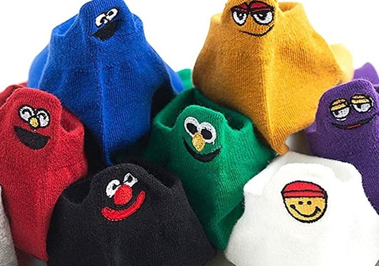colorful socks with muppet like faces on the heels 