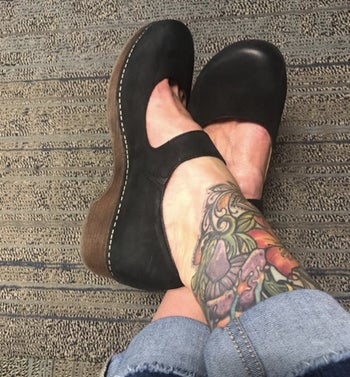 Reviewer pic of the black clogs with brown soles