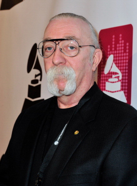 Baxter with a very distinctive mustache with images of a Grammy Award behind him