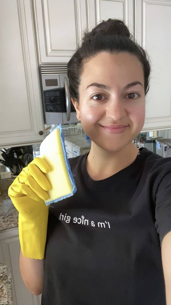 The author holding a cleaning sponge