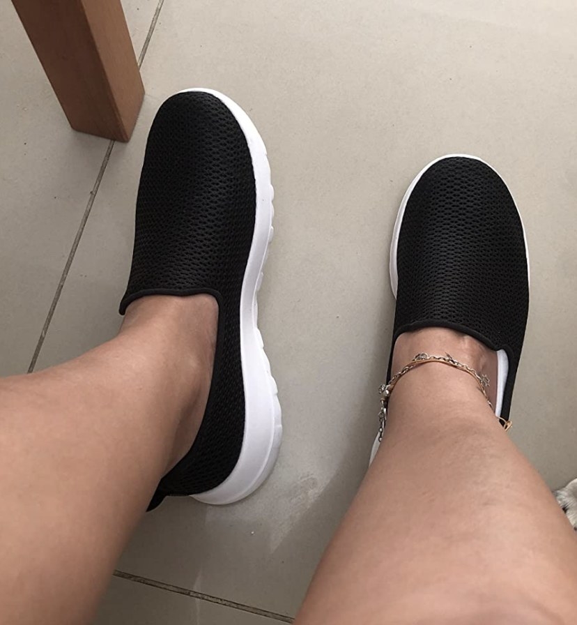Reviewer photo of black walking shoes with white soles