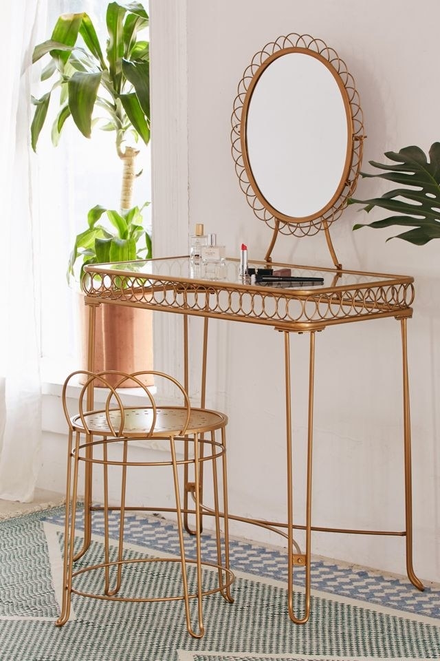 Glass-topped vanity with looped wire detailing and an oval mirror