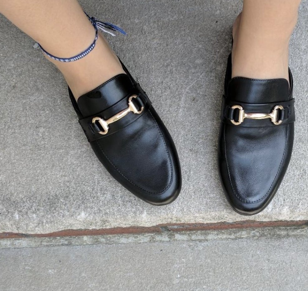 Reviewer pic of the black slip on loafers with a gold buckle on top