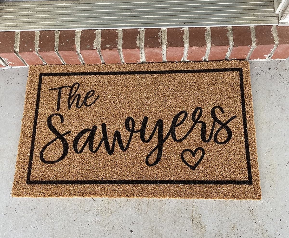 a door mat that says &quot;the sawyers&quot; with a heart
