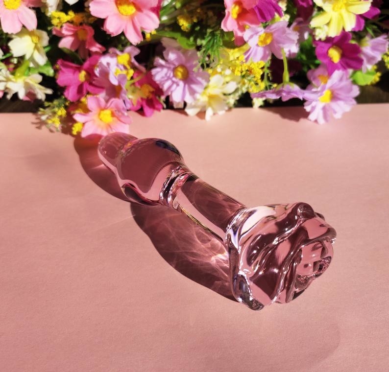 A glass butt plug with a beautiful rose head 