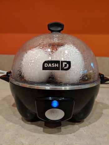 reviewer image of the black dash rapid egg cooker with eggs inside