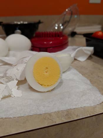 reviewer image of a hardboiled egg sliced in half to reveal a fully cooked yolk