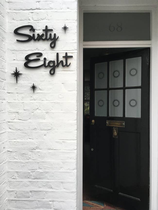 sixty eight written in a curvy black font next to someone's front door