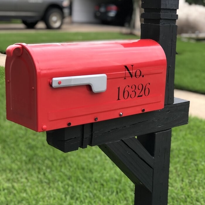 a reviewer&#x27;s red mailbox with a decal of numbers on it